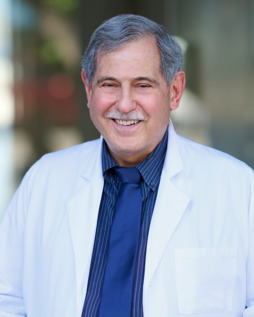 A professional headshot of Dr. John M. Scaramella